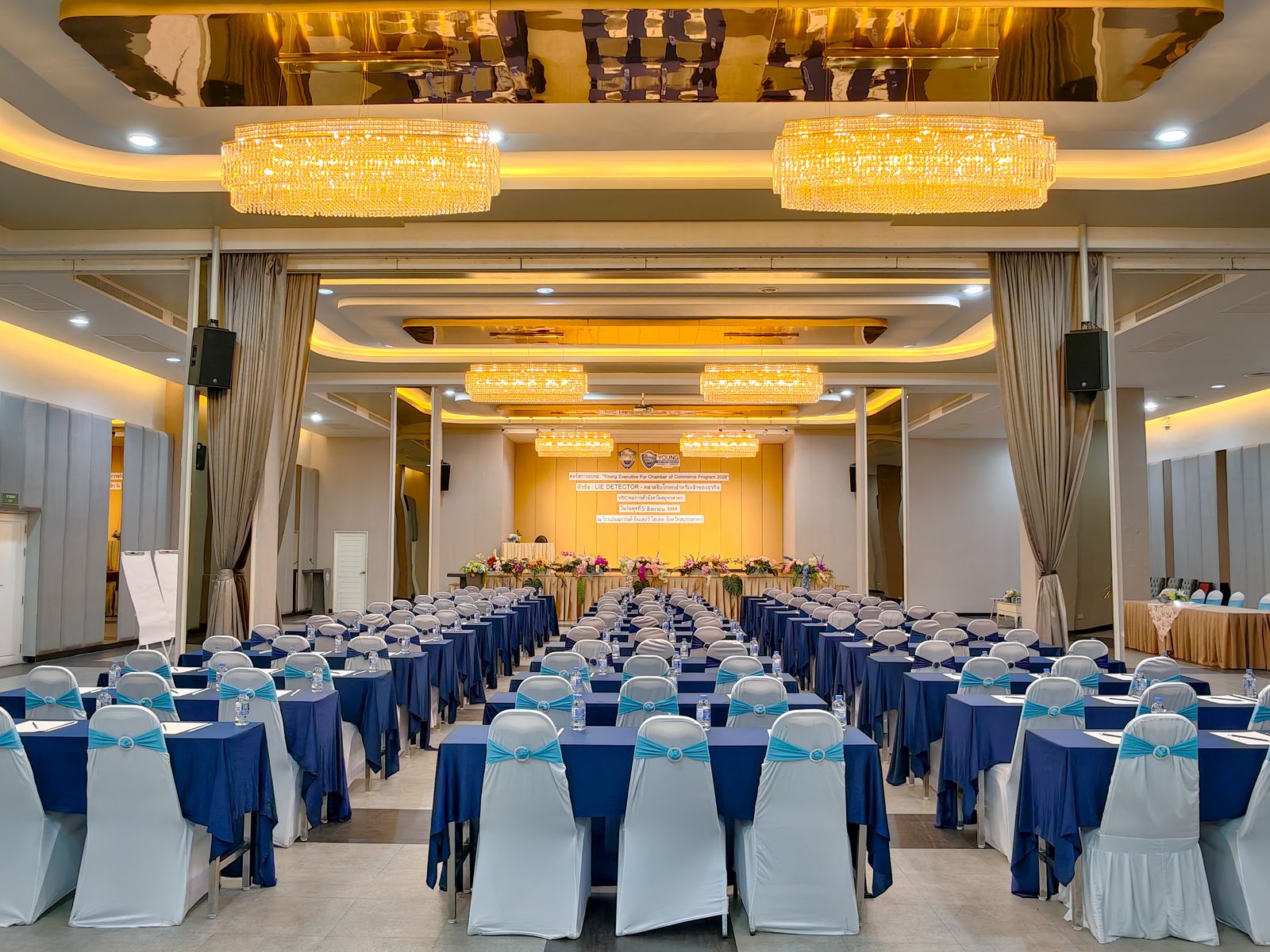 Ballroom seen from the back, with chandeliers and the stage