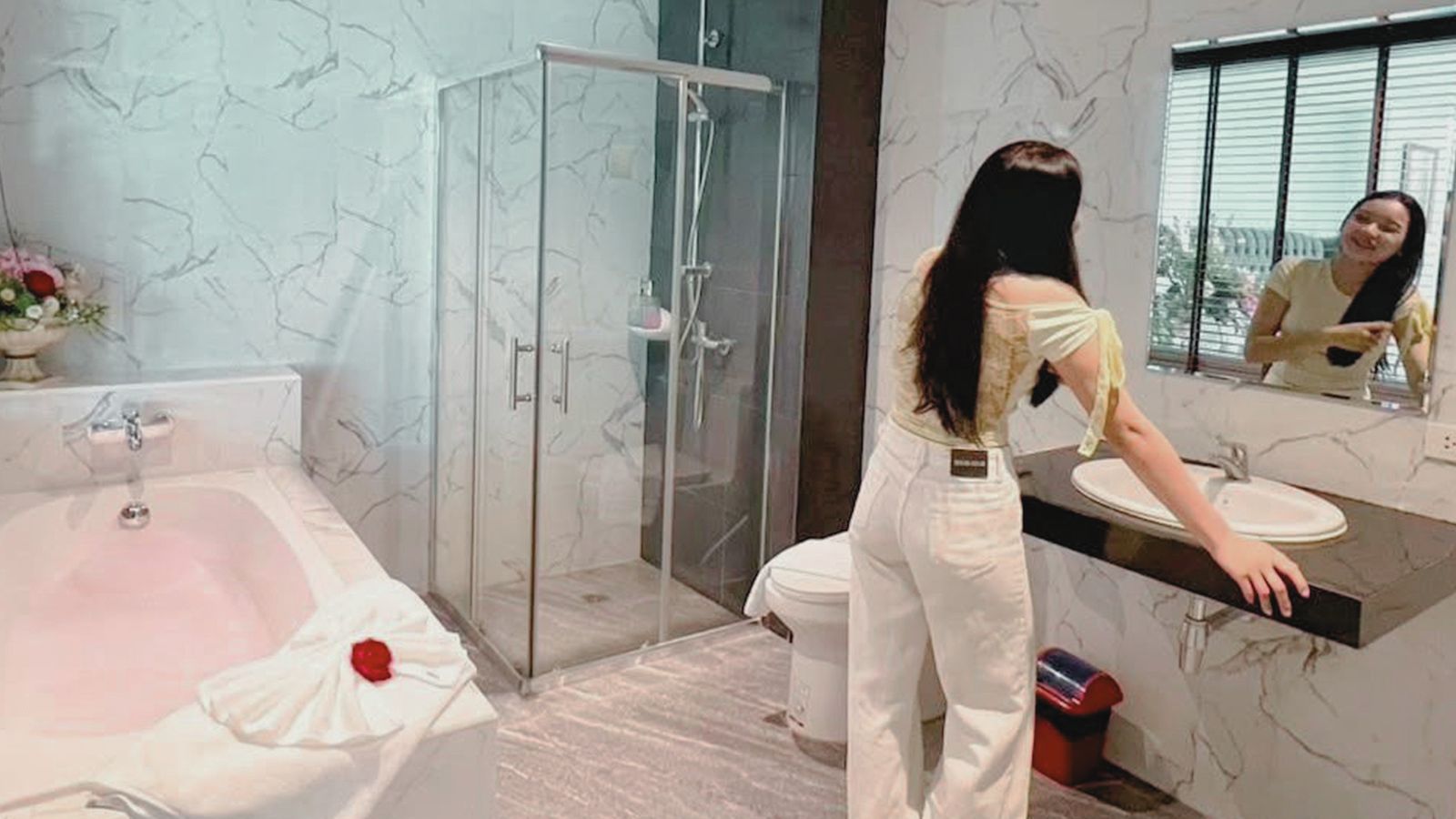 Marble bathroom with bathtub and glass shower