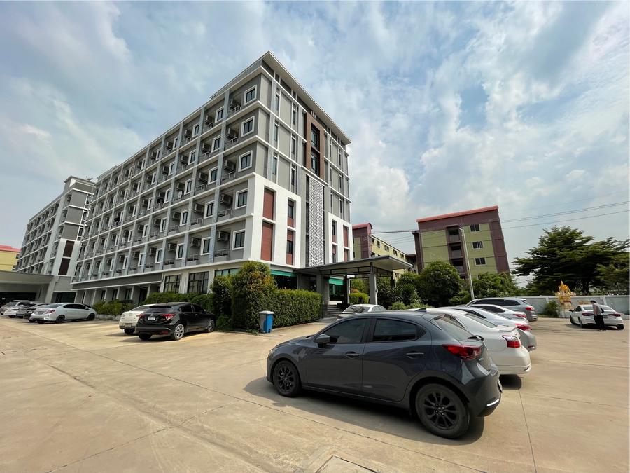 Hotel building and car park on a sunny day