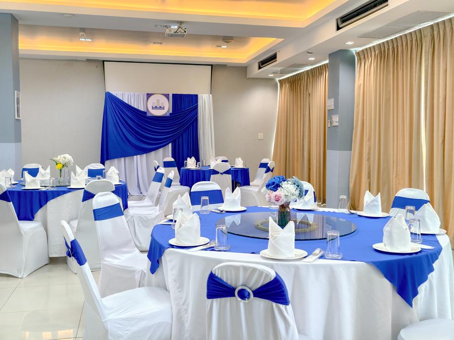 Round banquet table in front of the fabric backdrop