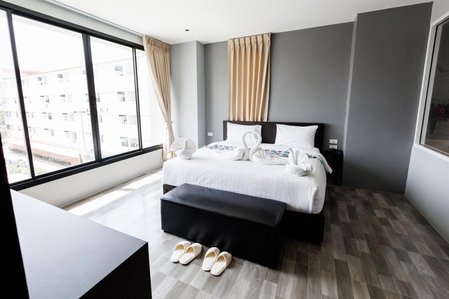 VIP Suite bedroom with large windows and a bench