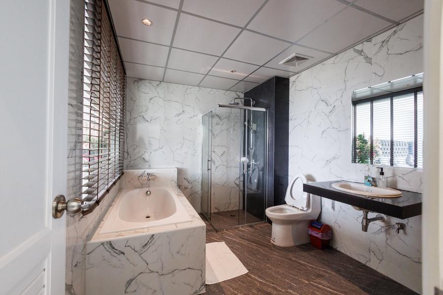 Honeymoon Suite marble bathroom with bathtub and glass shower