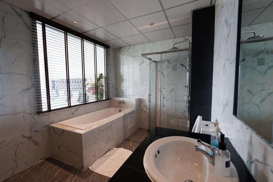 VIP Suite marble bathroom with bathtub and vanity
