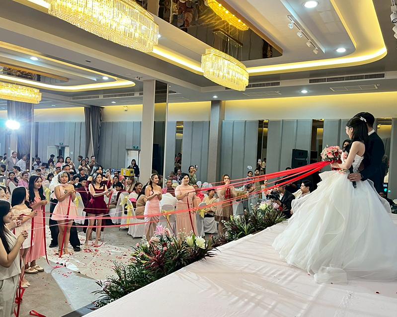 Ribbon ceremony beneath crystal chandeliers