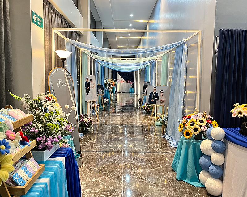 Wedding entrance styled with drapes, flowers and photo displays