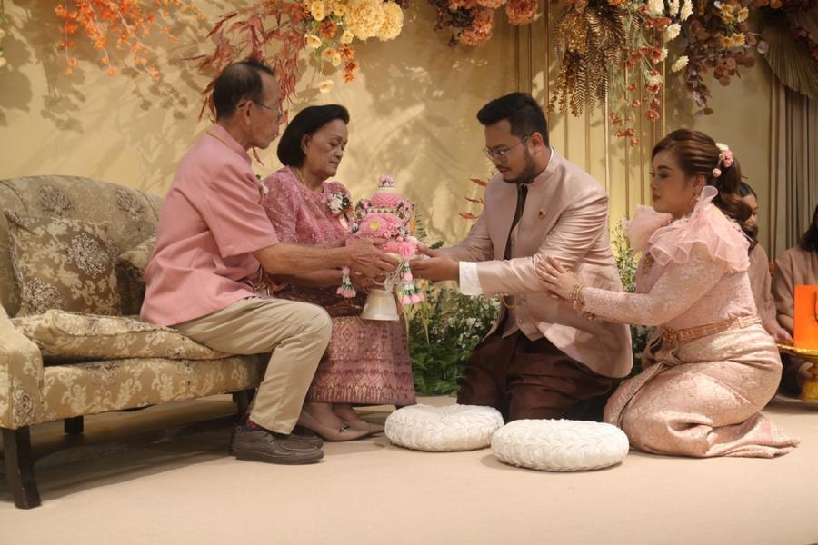 Couple paying respect to their parents on stage