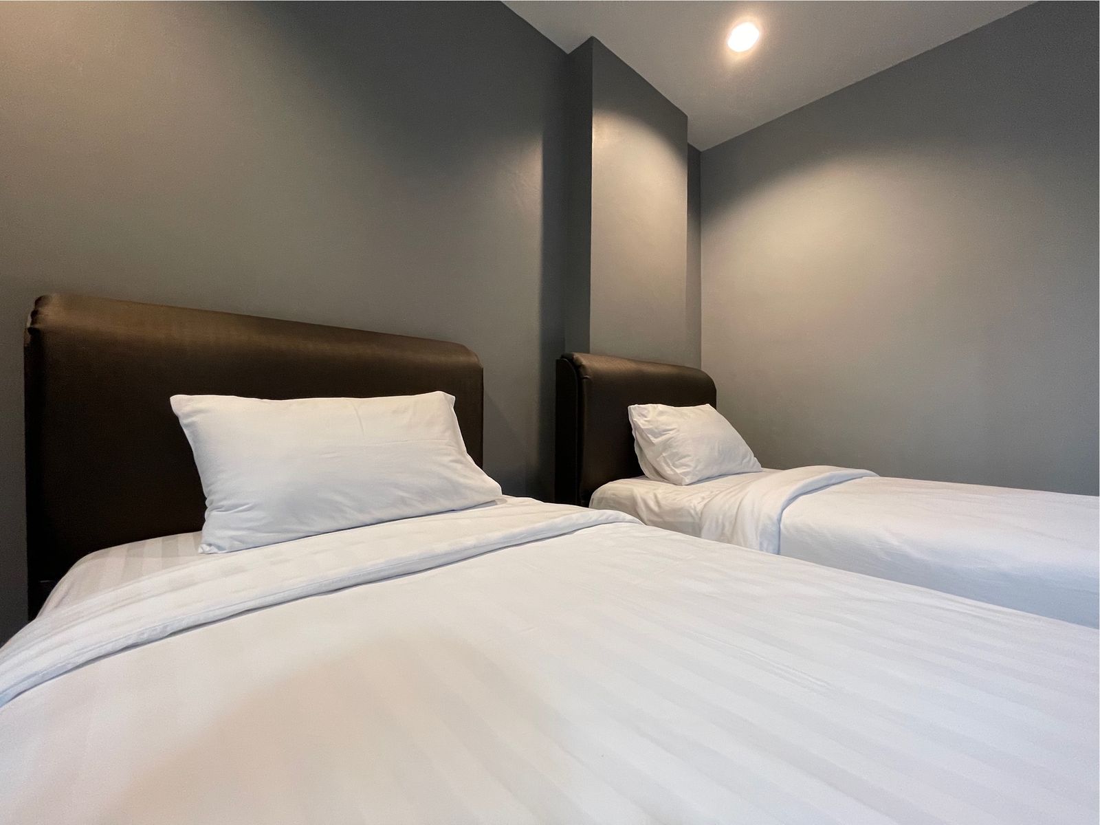 Twin beds with soft white linen