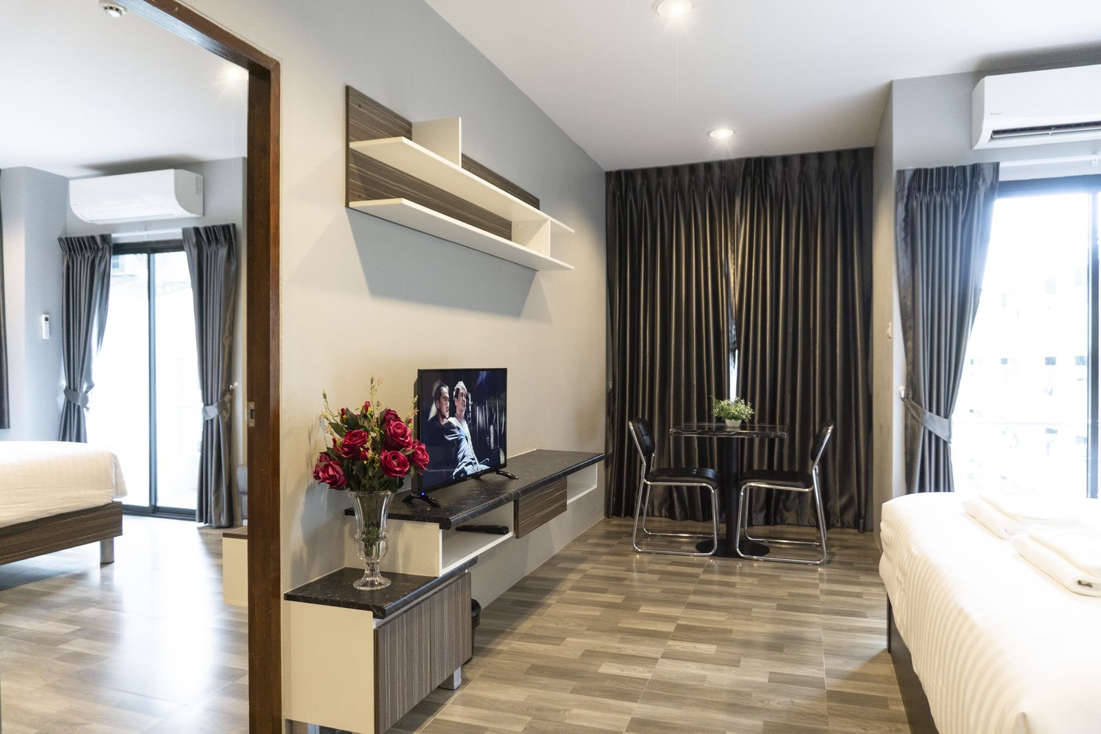 Living area with TV, dining table and bed