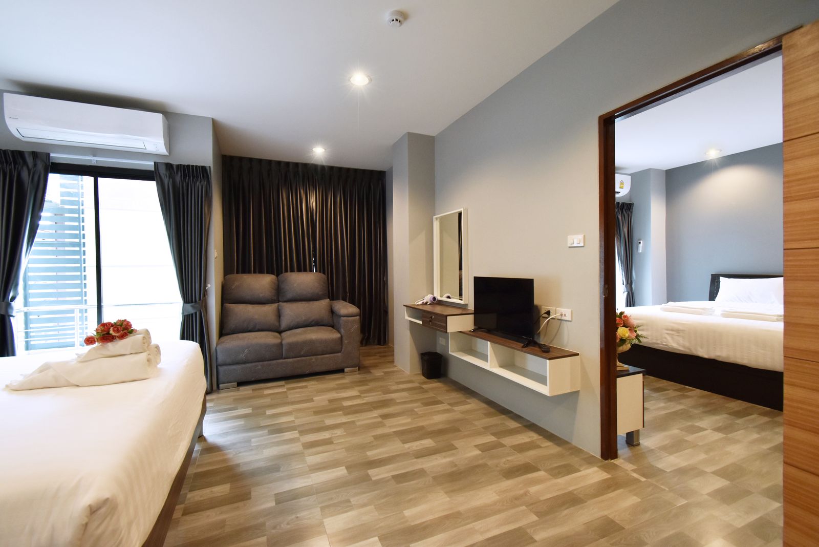 Sofa and TV with a view into the bedroom