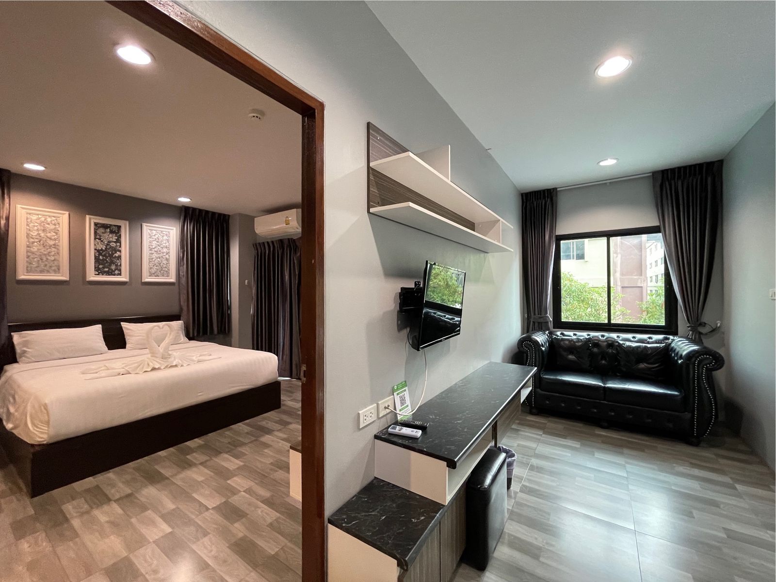 Bedroom and sitting area with leather sofa