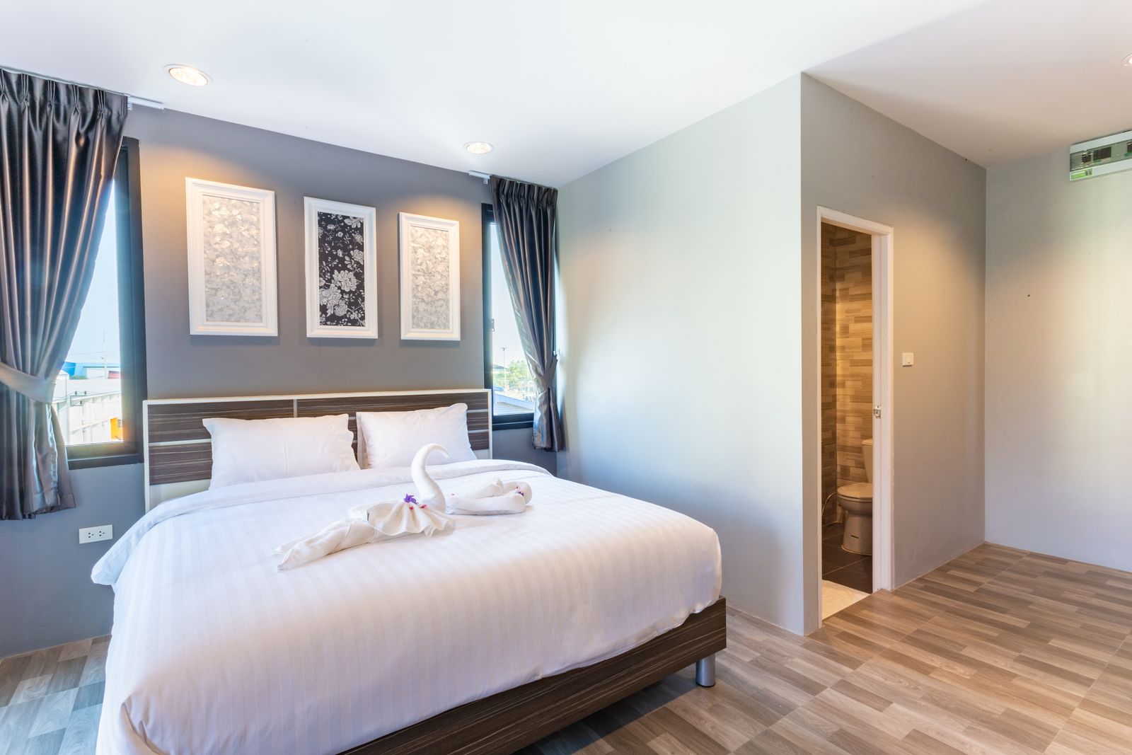 Family room with a double bed, framed artwork and en-suite door
