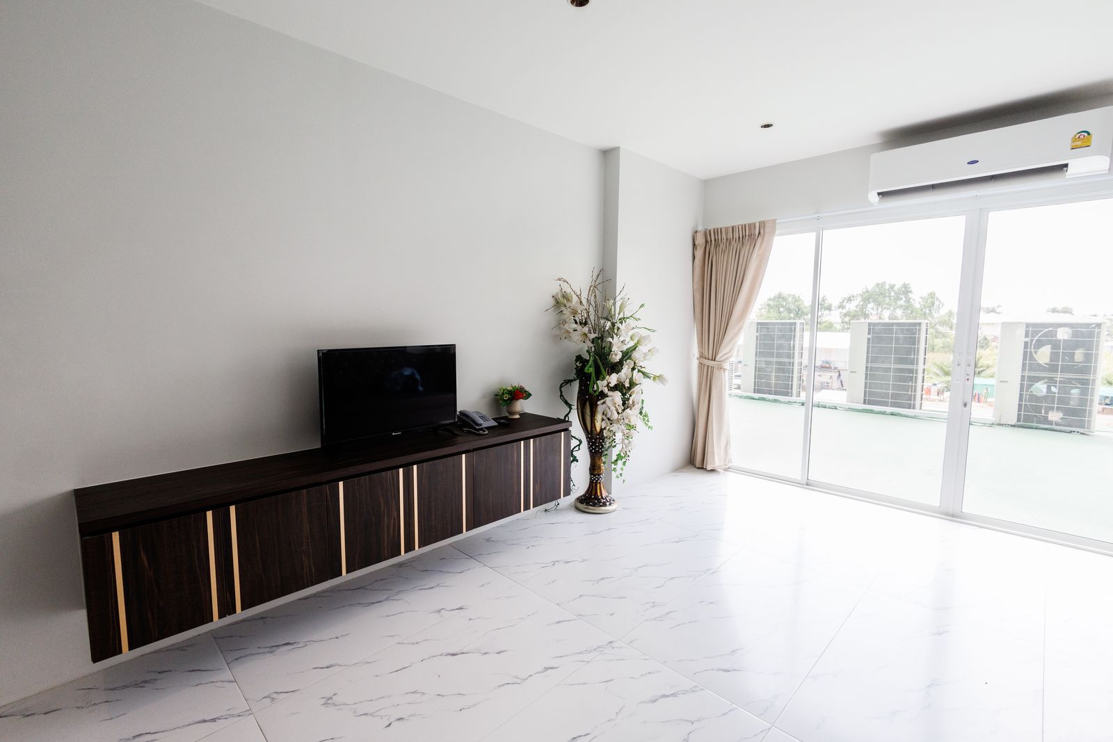 TV console and windows onto the terrace