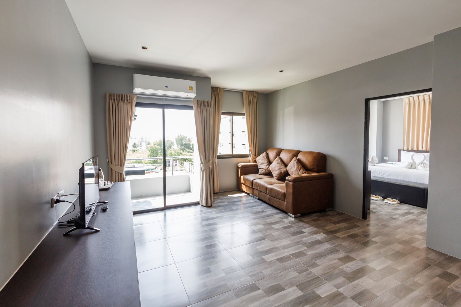 Living room with sofa and a view into the bedroom