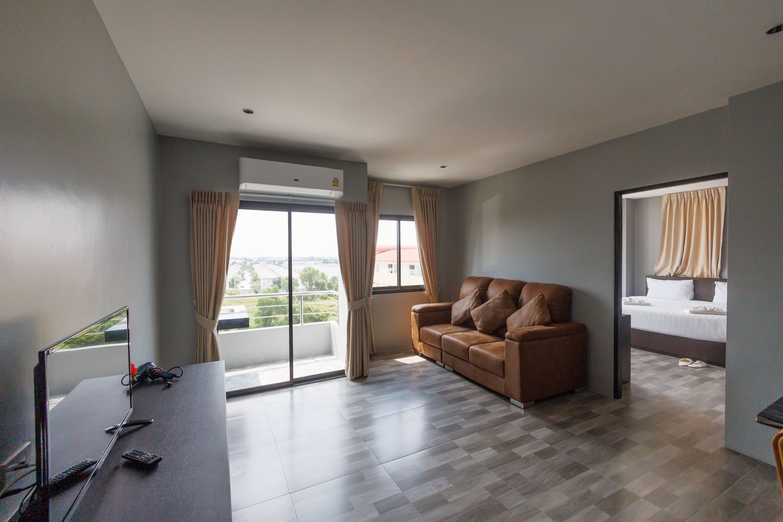 Living room with leather sofa and balcony doors