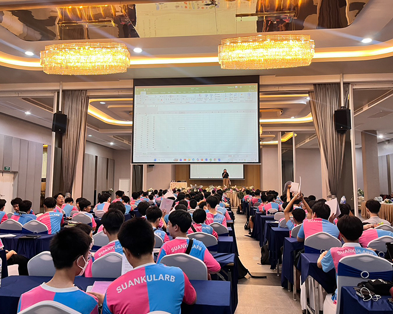 Students attending a training session in the ballroom with a large projector screen
